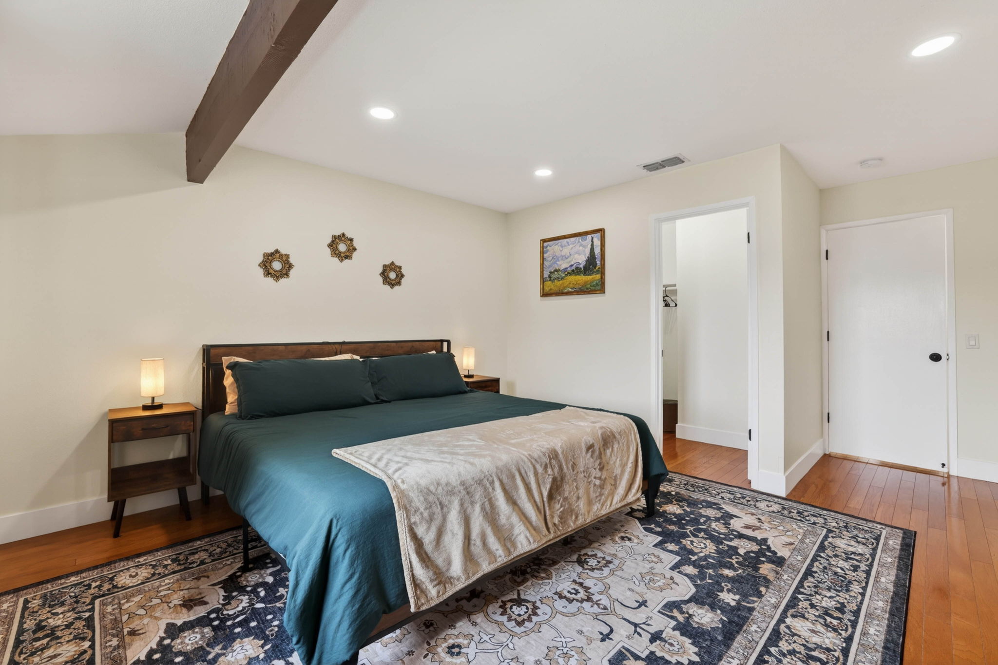 Primary bedroom with exposed wood beam